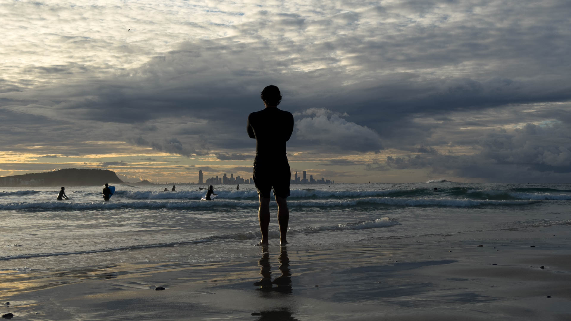 First light over Currumbin, a figure silhouetted against the dawn surf.