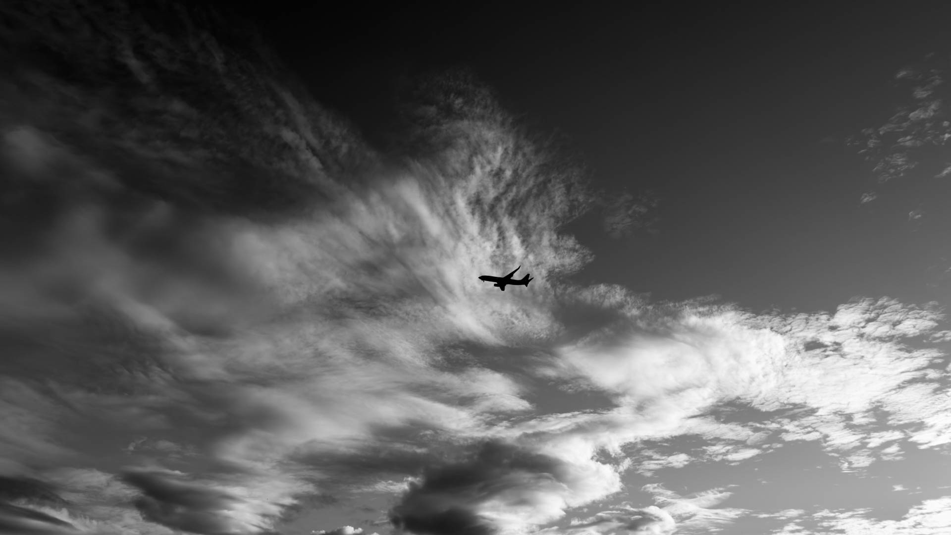 A jet silhouetted on approach over Currumbin, ten minutes from Gold Coast Airport.