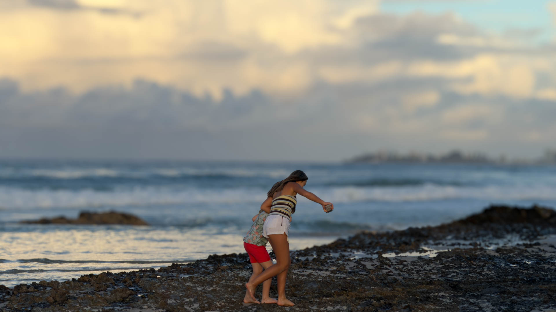 Children playing on the rocks at Currumbin.